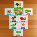 Educational vegetable cards with images and names on a wooden surface